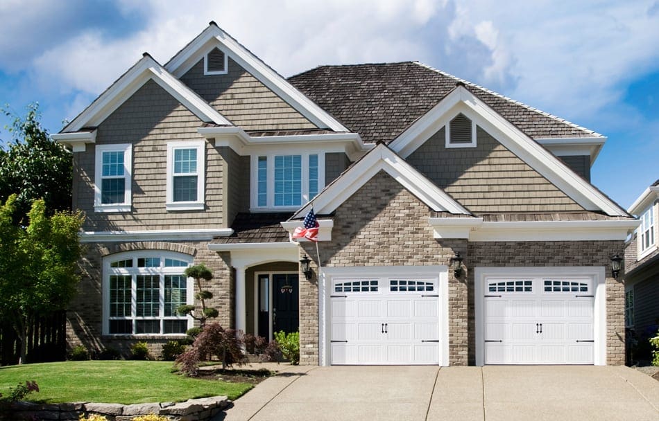 2 story home with white 2 car garage.