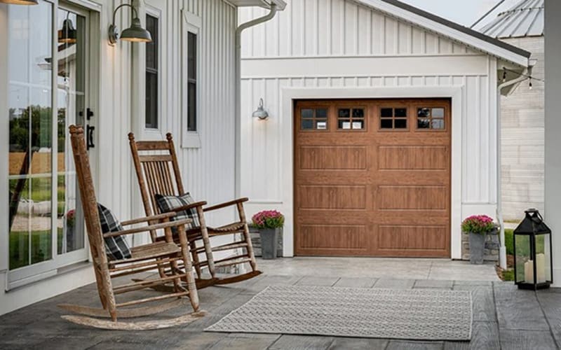 Rustic looking garage door with rocking chairs